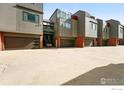 Modern townhouse complex features garages, brick accents, and well-maintained landscaping at 854 Walnut St # B, Boulder, CO 80302
