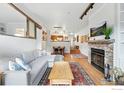 Cozy living area with fireplace, wood floors, and an open floor plan to dining room at 854 Walnut St # B, Boulder, CO 80302