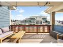 Relaxing outdoor deck with seating area and a view of surrounding neighborhood at 883 Widgeon Cir, Longmont, CO 80503