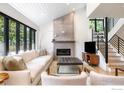 Cozy living room boasts a modern fireplace, a large window offering natural light, and a modern staircase at 950 Quince Ave, Boulder, CO 80304