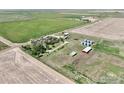 An aerial shot features farm buildings, silos, and fields, providing a comprehensive view of the property's layout at 0 Tbd E 112Th Ave, Bennett, CO 80102
