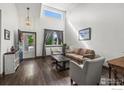 Bright living room featuring high ceilings, a large window, and stylish decor and neutral paint at 11861 Fairplay St, Commerce City, CO 80603
