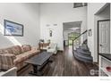 Spacious living room showcasing hardwood floors, a staircase, and an open floor plan at 11861 Fairplay St, Commerce City, CO 80603
