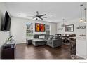 Comfortable living room featuring hardwood floors, a modern ceiling fan and plenty of light at 12724 Leyden St # E, Thornton, CO 80602