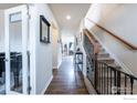 Inviting foyer with hardwood floors, staircase, and a view into the living spaces with lots of natural light at 1682 Dorothy Cir, Longmont, CO 80503