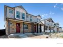 Street view of townhomes with charming facades and well-maintained landscaping at 18724 E 99Th Ave, Commerce City, CO 80022