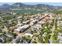 Stunning aerial view of the property nestled in a vibrant cityscape with mountain backdrop at 2025 18Th St, Boulder, CO 80302