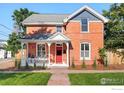 Inviting two-story brick home with a red front door and covered front porch at 2025 18Th St, Boulder, CO 80302