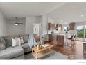 Open-concept living room with vaulted ceiling connects to the updated kitchen at 2037 Spencer St, Longmont, CO 80501