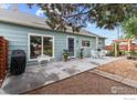 Cozy backyard patio with white furniture, a grill, and a charming ambiance perfect for outdoor relaxation and entertaining at 247 Tipple Pkwy, Frederick, CO 80530
