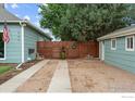 Property featuring a driveway with a privacy fence, connecting the house to the garage for convenient access at 247 Tipple Pkwy, Frederick, CO 80530