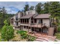 A large home featuring a deck, patio, stairs, mature trees, and nice landscaping at 2794 Linden Dr, Boulder, CO 80304