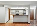 Bright kitchen with white cabinets, butcher block countertops, and stainless steel appliances at 2960 Shadow Creek Dr # 201, Boulder, CO 80303