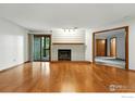 Spacious living room with a fireplace, hardwood floors, and sliding glass door to the outside at 2960 Shadow Creek Dr # 201, Boulder, CO 80303