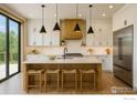 Bright kitchen features pendant lights, stainless steel appliances, light countertops, and breakfast bar seating at 300 Shining Star Trl # A, Boulder, CO 80302