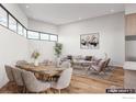 Open living and dining area with modern furnishings, natural light, and wood flooring at 300 Shining Star Trl # A, Boulder, CO 80302