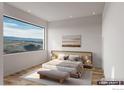 Serene main bedroom with large windows providing views, light wood floors and neutral decor at 300 Shining Star Trl # A, Boulder, CO 80302