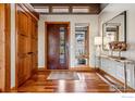 Welcoming entryway with wood accents, hardwood floors, and stylish decor at 3875 Cloverleaf Dr, Boulder, CO 80304