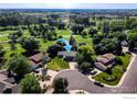 Aerial view of a home in a neighborhood near a golf course at 5004 Fox Hill Dr, Longmont, CO 80504