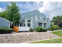 Side view of home showing rock garden, white fence and architectural windows at 5190 Buckingham Rd, Boulder, CO 80301