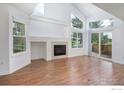 Living room featuring vaulted ceilings, fireplace, and sliding doors to outside at 5190 Buckingham Rd, Boulder, CO 80301