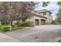 Stucco home featuring a driveway with a 2-car garage at 714 Skywalker Pt, Lafayette, CO 80026