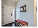 The entryway boasts a black-and-white tiled floor, a charming bench, and a welcoming door at 7196 Christopher Ct, Niwot, CO 80503