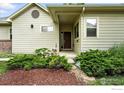A quaint entry way features a lovely front door, complimented by colorful landscaping at 7196 Christopher Ct, Niwot, CO 80503