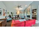 Bright living room with hardwood floors, fireplace, vaulted ceiling, and ample natural light at 7196 Christopher Ct, Niwot, CO 80503