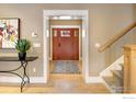 Inviting foyer with hardwood floors and a stylish entryway table at 832 Neon Forest Cir, Longmont, CO 80504
