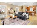 Open-concept living area with hardwood floors and seamless flow to the kitchen at 832 Neon Forest Cir, Longmont, CO 80504