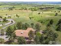Serene aerial view of a secluded home surrounded by lush greenery and a winding road at 8323 Thunderhead Dr, Boulder, CO 80302