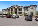 Well-maintained apartment building with stone facade and parking, conveniently located near shopping and dining at 875 E 78Th Ave # 53, Denver, CO 80229