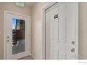 Hallway view showing the unit entry door number 68 and a door to an exterior stairwell and balcony at 875 E 78Th Ave # 68, Denver, CO 80229