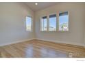 Bright bedroom with large windows offering natural light and scenic neighborhood views at 961 Eldorado Ln, Louisville, CO 80027