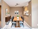 Cozy dining area with modern lighting fixture, a wooden table, and neutral décor at 13900 Lake Song Ln # 3, Broomfield, CO 80023