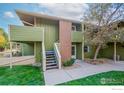 Exterior shot of the home with a patio and stairs leading to the upper level at 1410 Bacchus Dr # B12, Lafayette, CO 80026