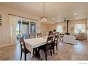 Inviting dining area with natural light, wood floors and seamless connection to the outdoor patio at 16527 Fairbanks N Rd, Platteville, CO 80651