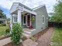 Inviting front porch with decorative columns and colorful potted flowers at 1750 Trenton St, Denver, CO 80220
