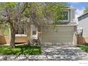 Well-maintained home featuring a spacious garage, inviting entryway, and lush green lawn at 17611 Hoyt Pl, Parker, CO 80134