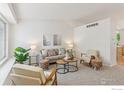 Bright living room with vaulted ceilings, neutral decor, and comfortable seating arrangements at 17611 Hoyt Pl, Parker, CO 80134