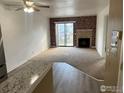 Spacious living room with a brick fireplace and a sliding glass door to the outside patio at 225 E 8Th Ave # B11, Longmont, CO 80504