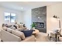 Stylish living room features a modern fireplace, neutral tones, and comfortable seating at 2744 Bear Springs Cir, Longmont, CO 80503