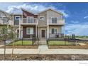 Charming townhome featuring a private balcony, fenced yard, and stone accents at 2770 Bear Springs Cir, Longmont, CO 80503