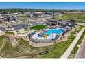 Community pool with clubhouse, playground, parking, and surrounding homes at 2770 Bear Springs Cir, Longmont, CO 80503