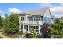 Stylish two-story home with a cozy porch, second-story balcony, and mature trees at 2856 Shadow Lake Rd, Lafayette, CO 80026