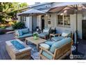 Enjoyable patio area with plush seating, shade umbrellas, and a modern fire pit feature at 2942 4Th St, Boulder, CO 80304