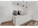 Contemporary kitchen with stainless steel appliances, white cabinetry and quartz countertops at 3100 Huron St # 1D, Denver, CO 80202