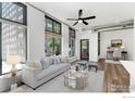Bright living room with large windows, modern furniture, and a view of the outside at 3100 Huron St # 1D, Denver, CO 80202