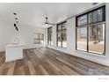Open living space with hardwood floors, white walls and bright, natural light at 3100 Huron St # 1D, Denver, CO 80202